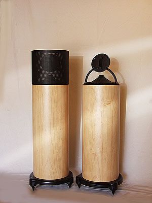 two wooden speakers sitting next to each other on top of a white tablecloth covered floor