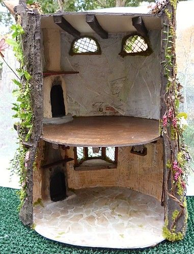 a doll house made out of wood and plants