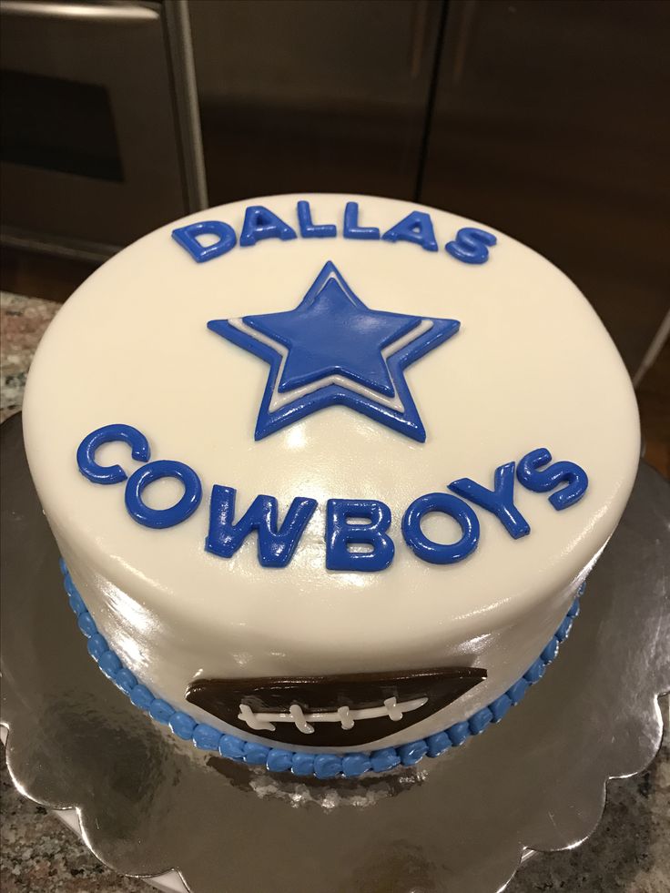 a birthday cake with the name cowboys on it and a blue star in the middle