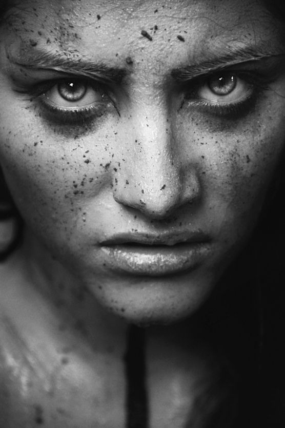 a black and white photo of a woman with freckles on her face