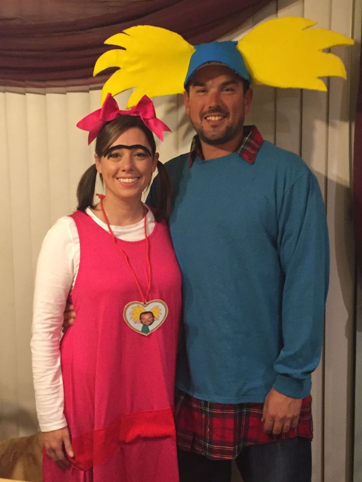 a man and woman standing next to each other in front of a dr seuss costume