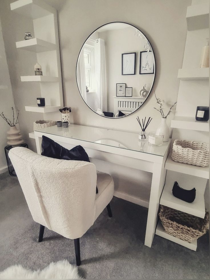 a white desk with a mirror, chair and shelves in front of it on the wall