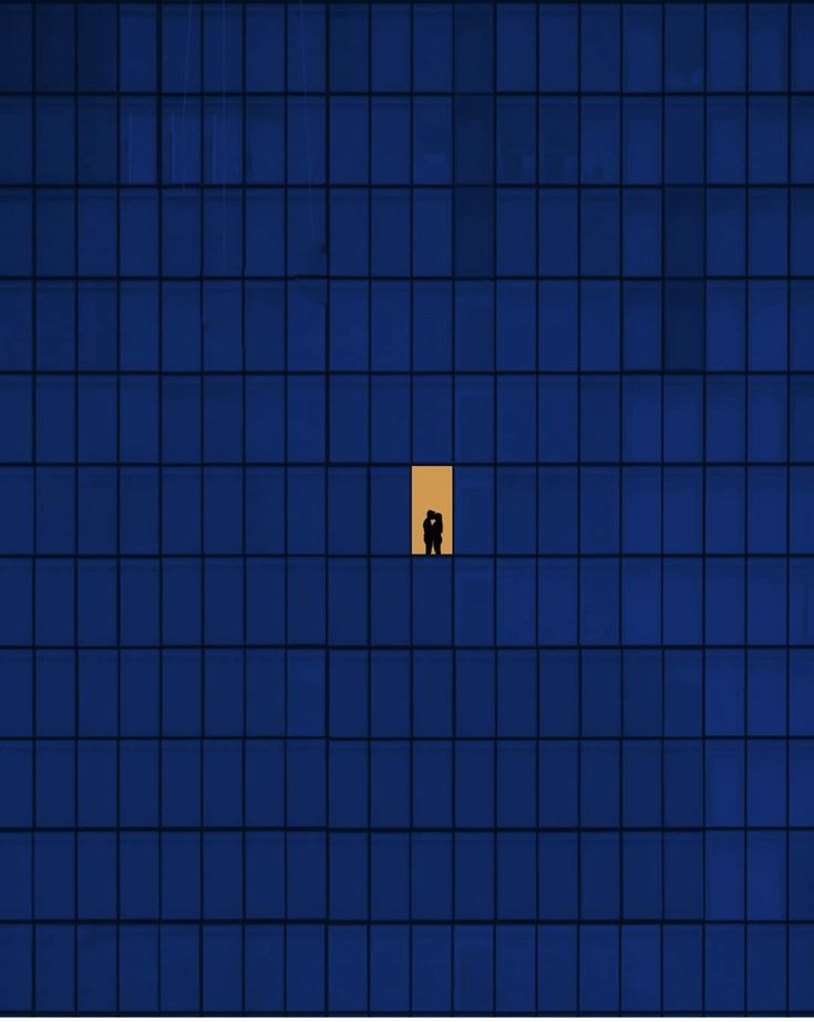 an image of a person standing in the middle of a room with blue tiles on it