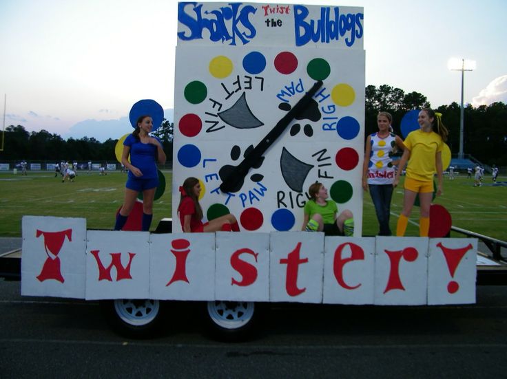 some people are standing on the back of a truck that is decorated like a clock