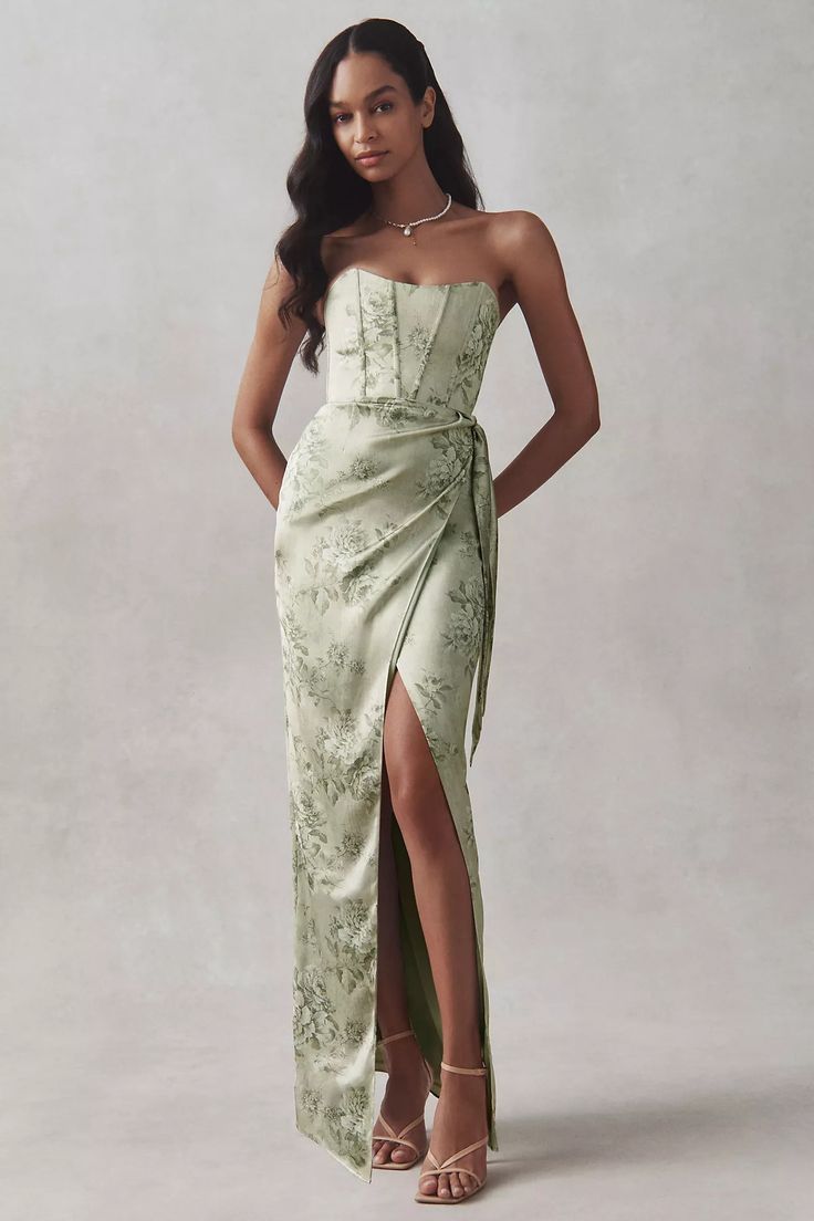 a woman in a green dress posing for the camera