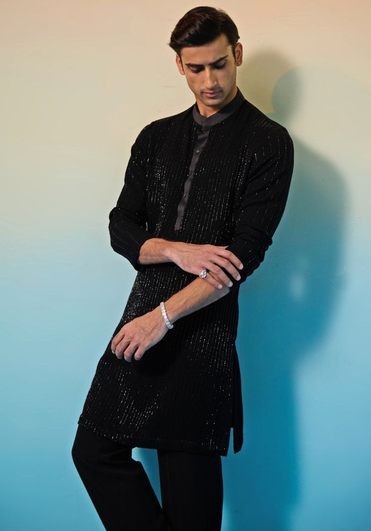 Step out in style with our Black Embroidered Silk Kurta Set. This stunning ensemble features a heavily embellished cutdana kurta with a satin collar and placket, perfectly paired with sleek black pants. Ideal for formal occasions like cultural celebrations, festive gatherings, or evening receptions. Elevate your look and embrace the elegance of this exquisite kurta set. Composition : Kurta & Pants: Tokyo Silk Care: Dry Clean Only and Vacuum Storage This product can be customized for sleeves, length of blouse and neckline Delivery : 4-6 weeks as the product is hand crafted. Check Size Guide or choose MySize for free customisation (All Sizes above XL can be made at 15% additional cost) For more information and sizes please contact fabiliciousfashion@gmail.com or visit our Copenhagen studio. Kurta Pants, Silk Kurta Set, Vacuum Storage, Indian Wedding Wear, Silk Kurta, Cultural Celebration, Kurta With Pants, Kurta Set, Wedding Wear