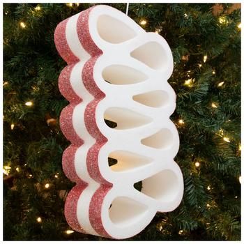 a white and red ornament hanging from a christmas tree