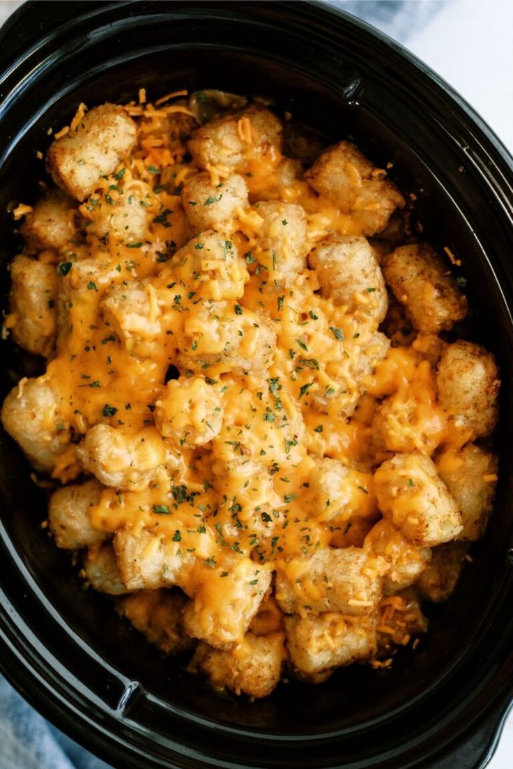 a crock pot filled with tater tots and cheese