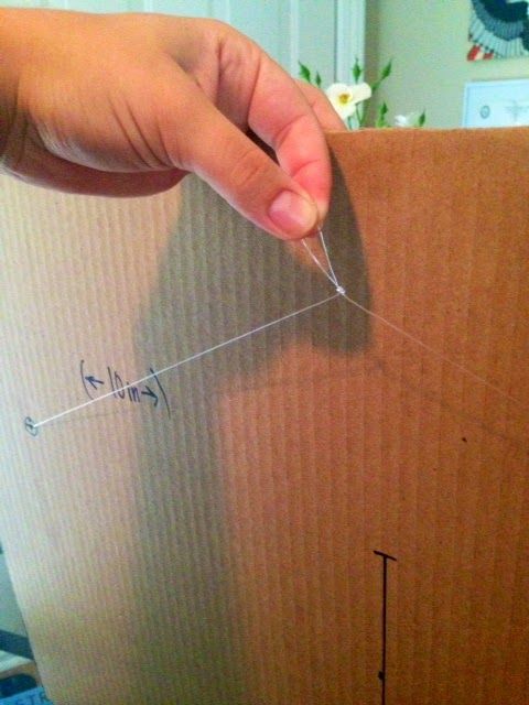 someone is opening up a cardboard box with some string