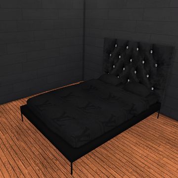 a bed sitting in the middle of a room next to a brick wall and wooden floor