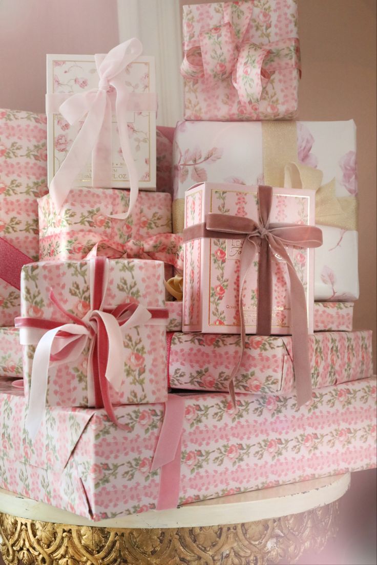 a stack of pink and white wrapped presents