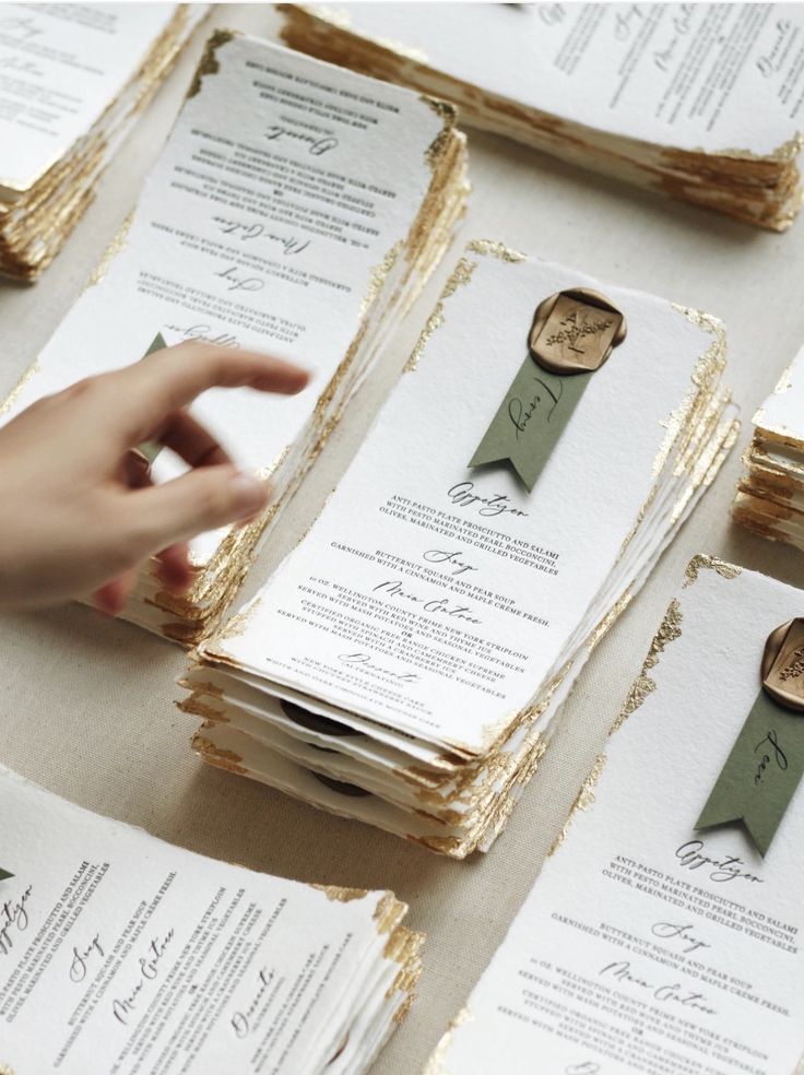 a table topped with lots of cards and envelopes covered in waxed paper on top of each other