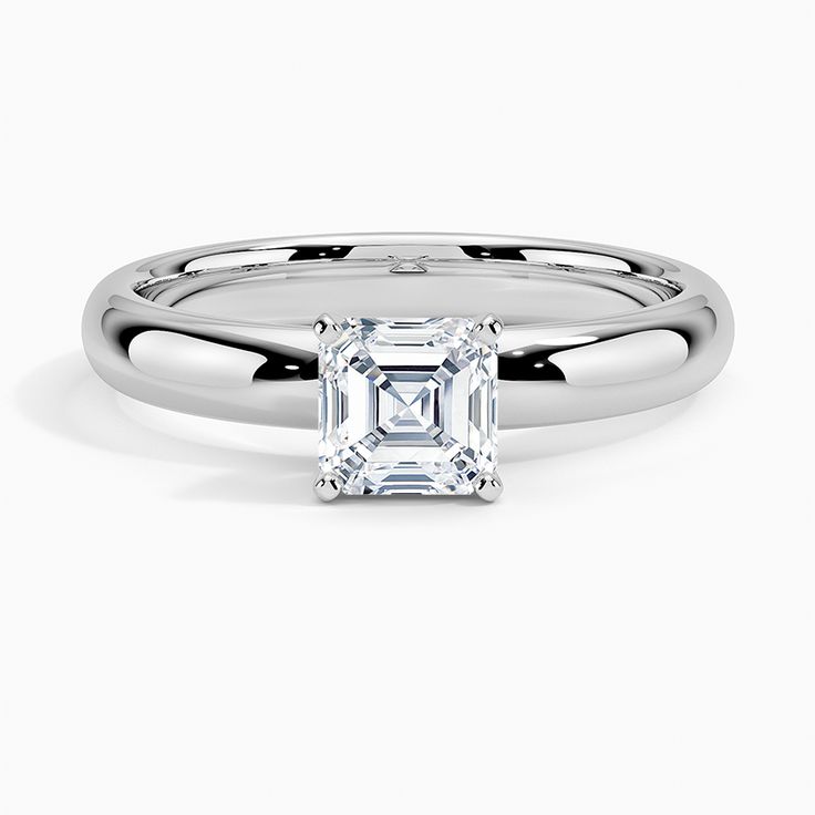 a white gold ring with an emerald cut diamond