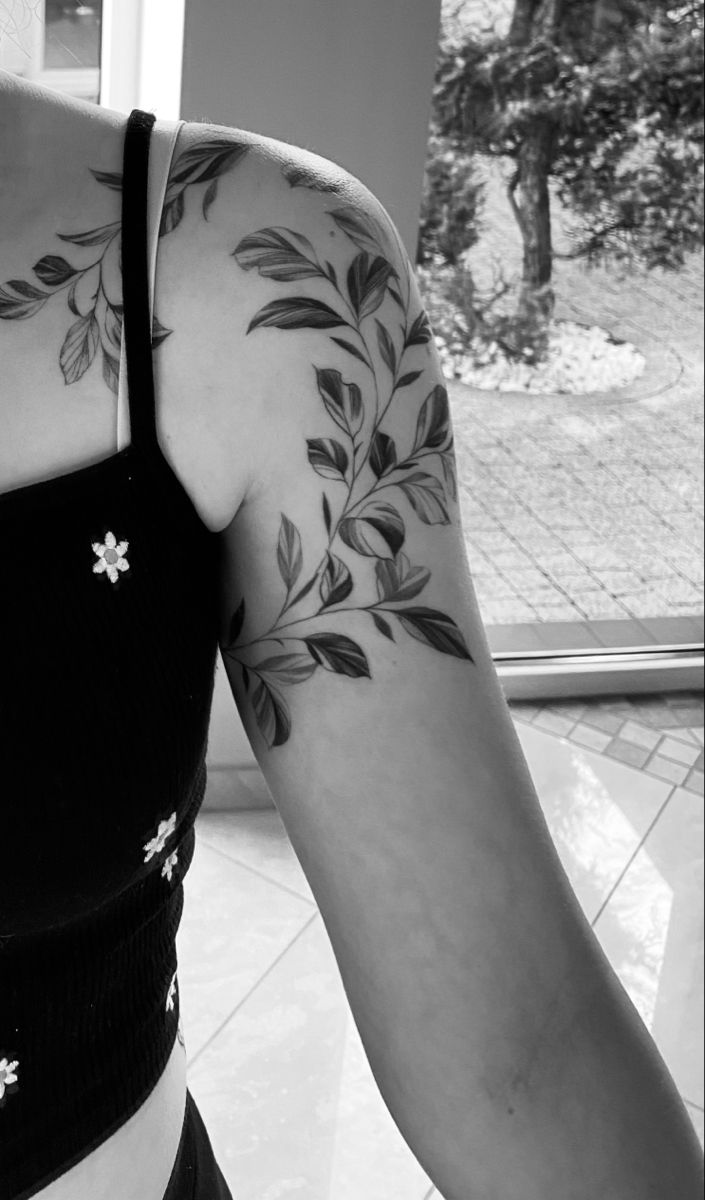 a woman with a flower tattoo on her arm