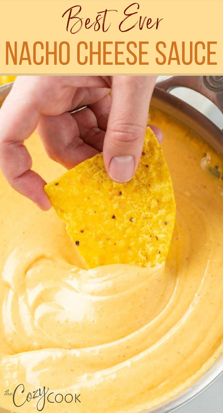 A hand dipping a tortilla chip into a skillet of Nacho Cheese sauce. Nachos With Nacho Cheese Sauce, Best Nacho Dip Recipes, Cheese Sauce For Nachos Without Velveeta, Fiesta Nacho Cheese Soup Dip, Cheese Sauce With Velveeta Recipe, Nacho Cheese Sauce Velveeta Rotel, Crockpot Nachos Cheese, Melted Velveeta Cheese Sauce, Nacho Cheese Sauce Instant Pot