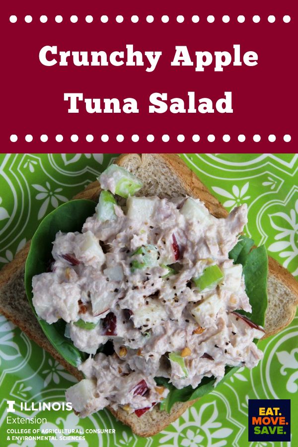 a green plate topped with toasted bread covered in tuna salad next to a red and white sign that says crunchy apple tuna salad