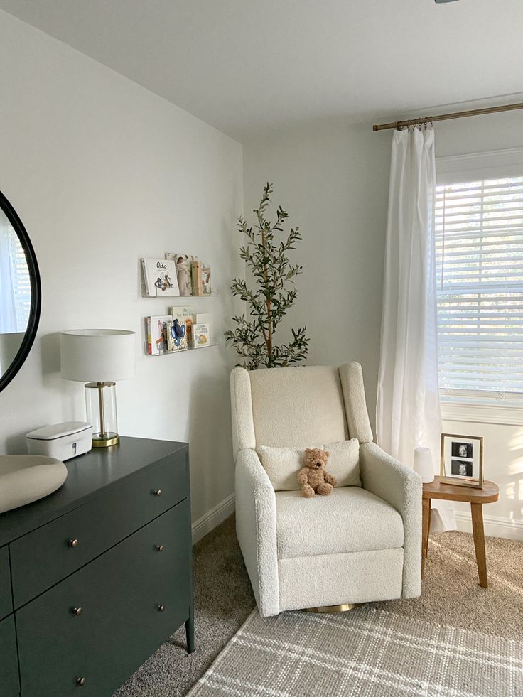 a living room filled with furniture and a large mirror on the wall next to a dresser