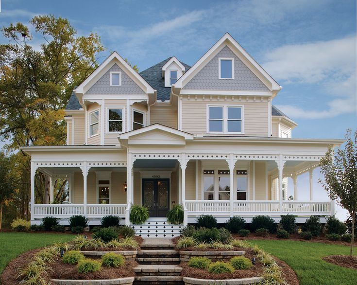 a large white house sitting on top of a lush green field