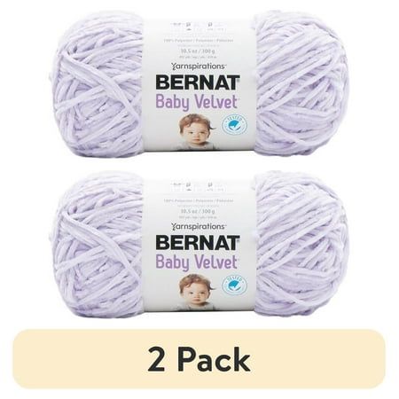 two balls of bernat baby velvet yarn, each in white and one in light purple