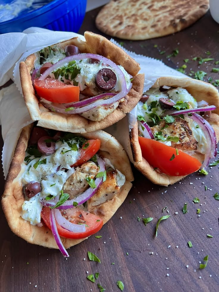 three pita breads filled with meat and vegetables