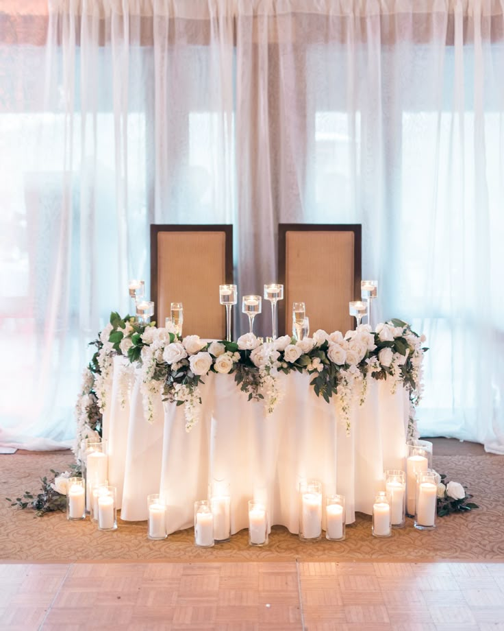 a table with candles and flowers on it