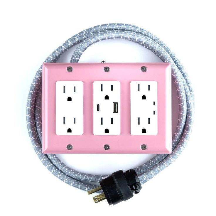 the pink electrical outlet cover is plugged in to an extension cord with two black and white outlets