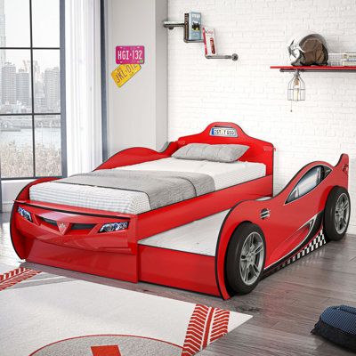 a child's bedroom with a red race car bed