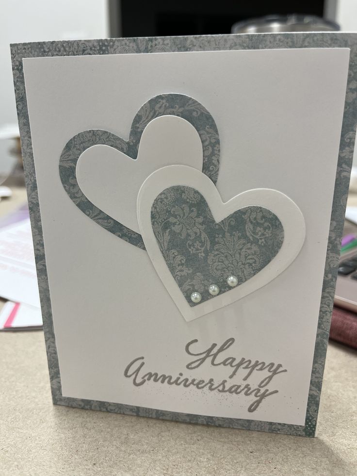 an anniversary card with two hearts on it