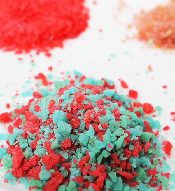 red, green and blue sprinkles are scattered on a white surface