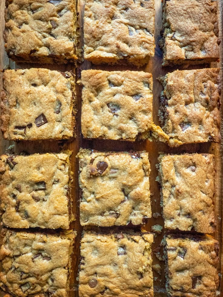 chocolate chip cookie bars cut into squares on top of a baking sheet, ready to be eaten