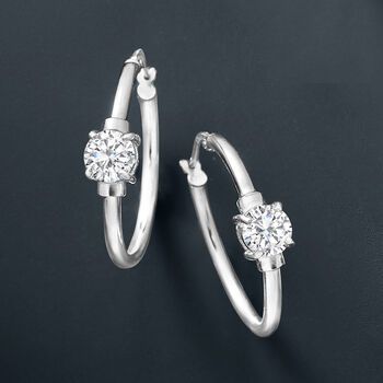 Ross-Simons - 1.60 ct. t. w. Cubic Zirconia Station Hoop Earrings in Sterling Silver. 1". CZ the moment. Sleek sterling silver hoop earrings sparkle with 1.60 ct. t. w. CZ stations. Hanging length is 1". Snap-bar, CZ hoop earrings. CZ weights are diamond equivalents. Classic Silver Small Hoop Diamond Earrings, Classic Silver Hoop Diamond Earrings, Classic Sterling Silver Hoop Earrings With Diamond Accents, Classic Silver Hoop Earrings With Prong Setting, Classic Sterling Silver Hoop Earrings Channel Set, Classic Silver Earrings With Channel Set, Classic Sterling Silver Hoop Earrings With Diamond Cut, Classic Sterling Silver Diamond Cut Hoop Earrings, Anniversary Sterling Silver Hoop Earrings Channel Set