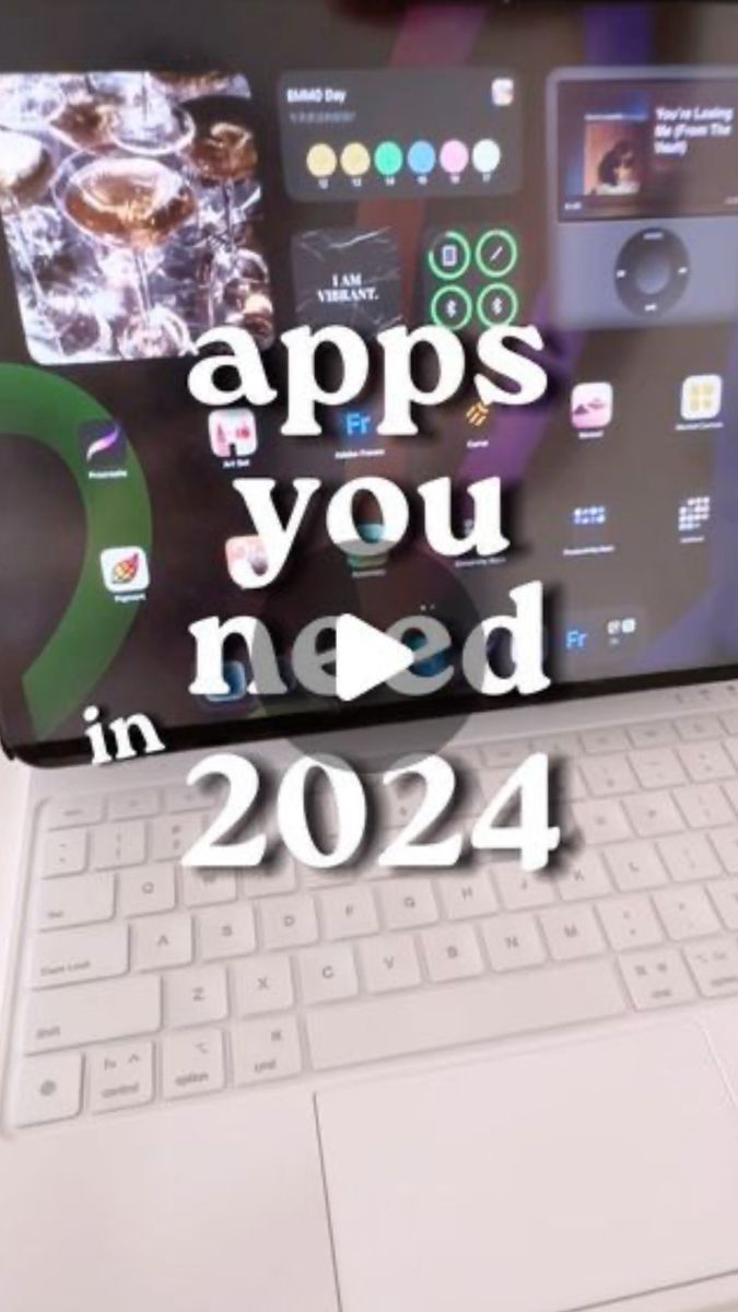 an open laptop with the words apps you need in 2021 written on it, next to a keyboard