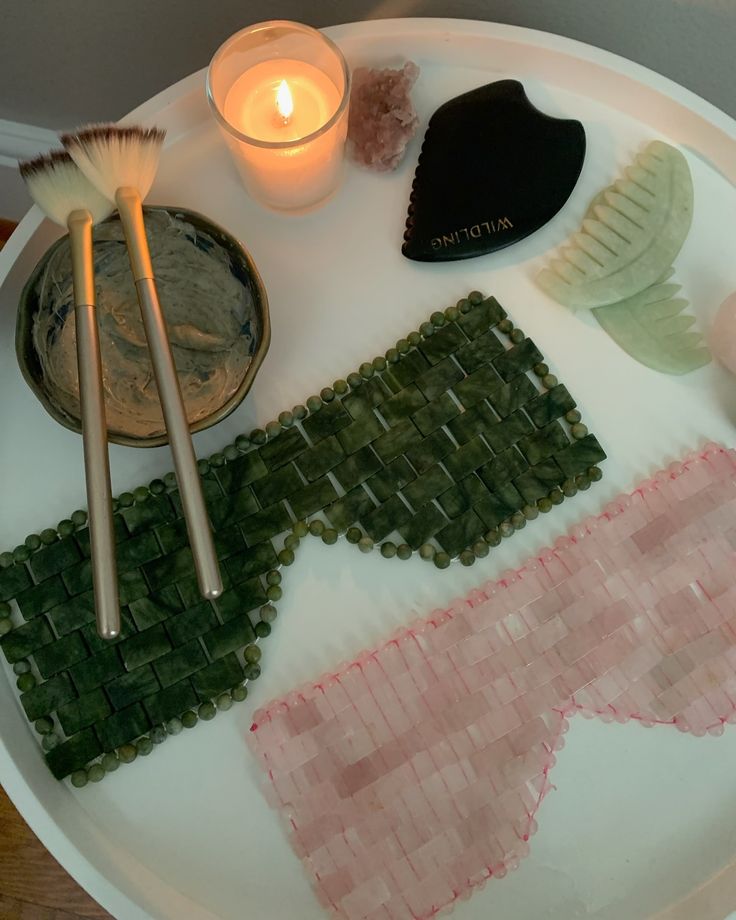 there is a plate that has different items on it and some candles in the background