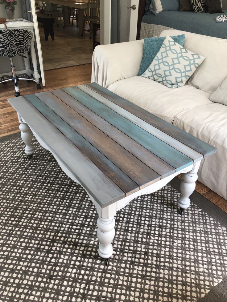 a living room with a couch, coffee table and rug