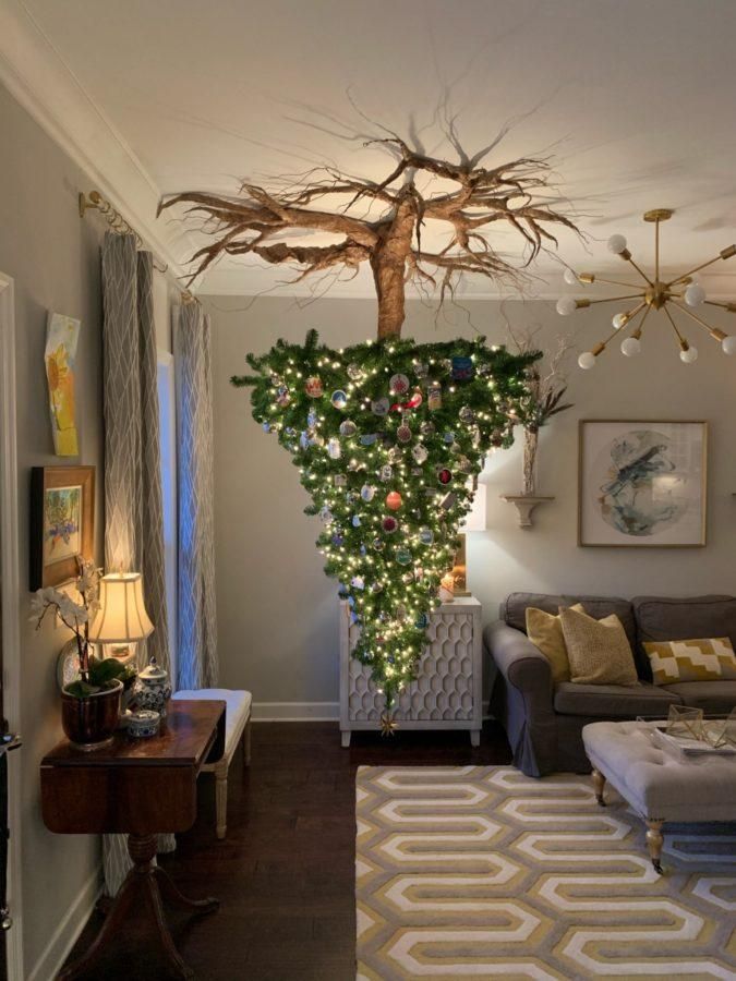 a living room filled with furniture and christmas lights hanging from the ceiling over a couch