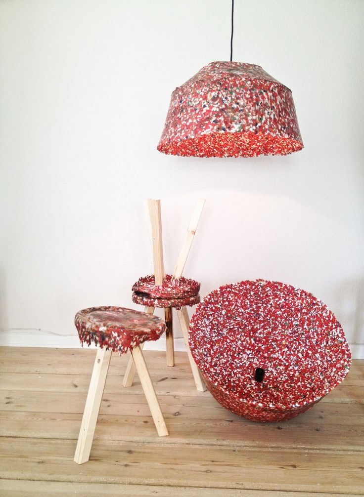 three stools and a lamp in a room with wood flooring on the ground