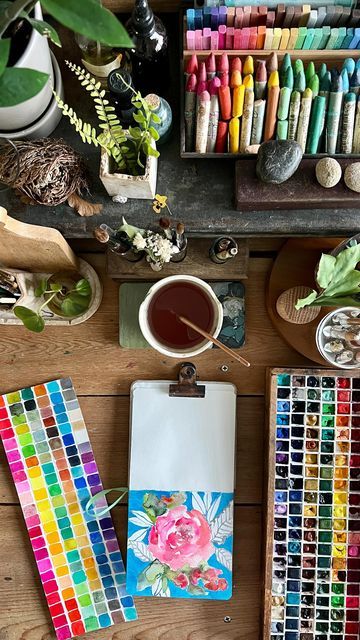 an assortment of art supplies on a wooden table