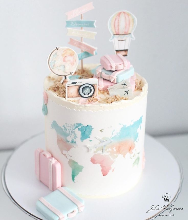 there is a small cake decorated with pink and blue decorations on top of the cake