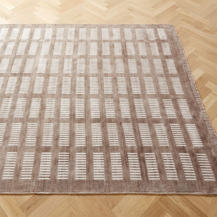 an area rug on the floor with wooden floors and parquets in the background