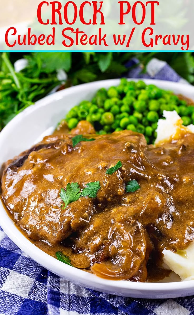 crock pot cubed steak w / gravy served with mashed potatoes and peas