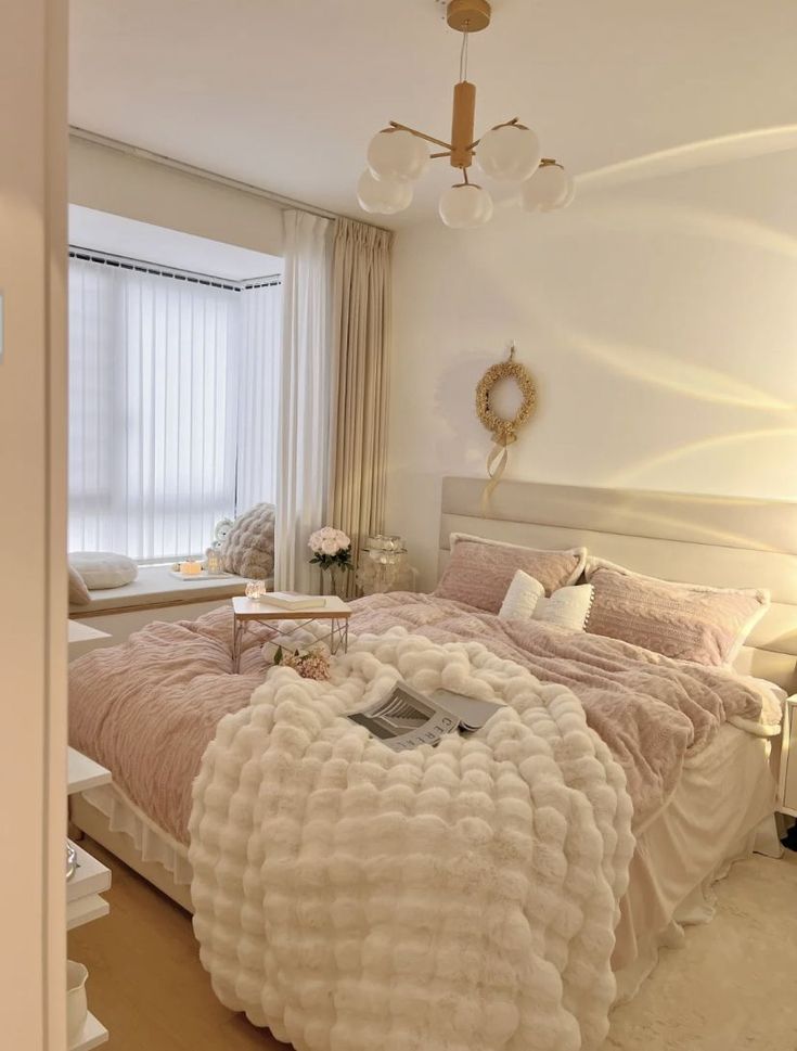 a bedroom with a large bed covered in fluffy blankets