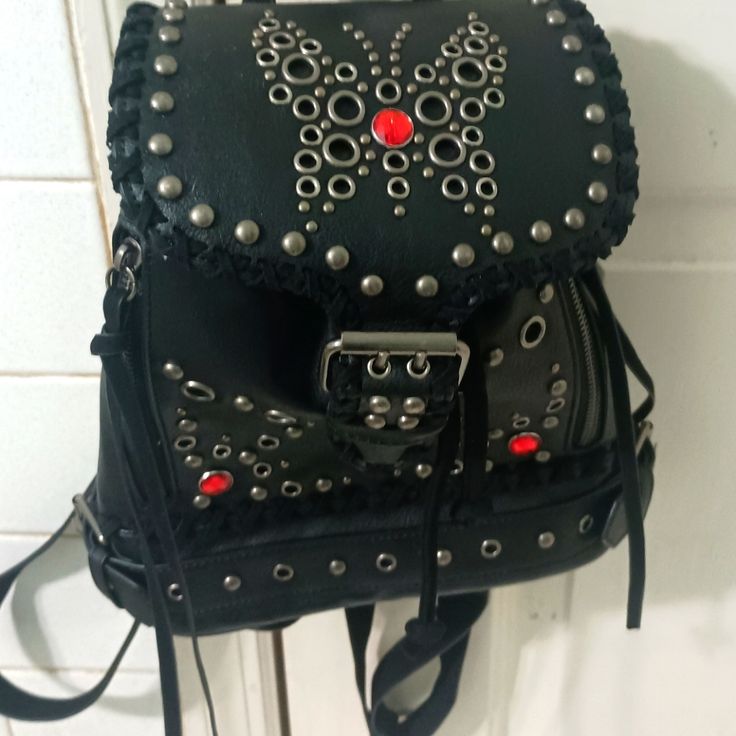 Current Mood Small Backpack Purse, Never Used, Brand New Without Tags. Black Faux Leather With Silver Stud And Red Stone Embellishments In The Shape Of A Butterfly. Adjustable Rivet Straps. Cute And Handy For Everyday Use. Gothic Standard Backpack For Everyday Use, Gothic Standard Backpack For School, Gothic School Backpack, Gothic Style School Backpack, Gothic Black Backpack Bag, Black Gothic Standard Backpack, Gothic Black Standard Backpack, Small Backpack Purse, Current Mood