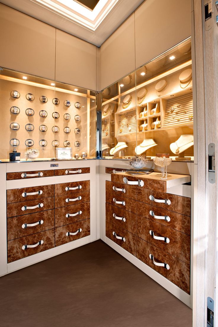 a kitchen with many drawers and cabinets in it's center wall, along with lights on the ceiling