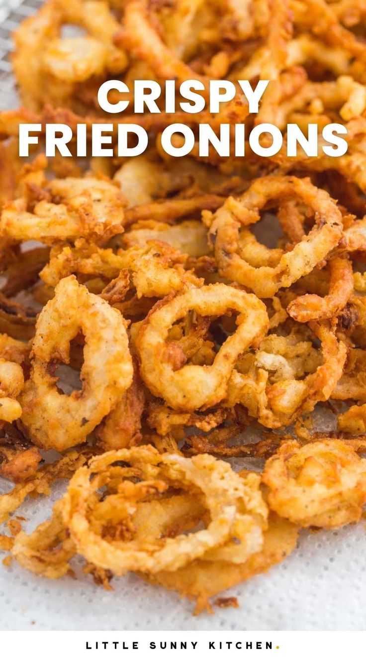 crispy fried onion rings on a white paper towel with text overlay that reads, crispy fried onions little sunny kitchen