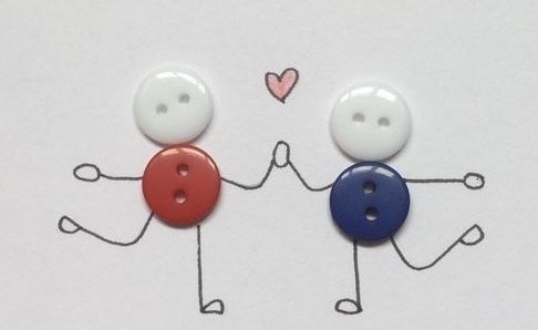 two buttons with faces drawn on them, one is holding the other's hand