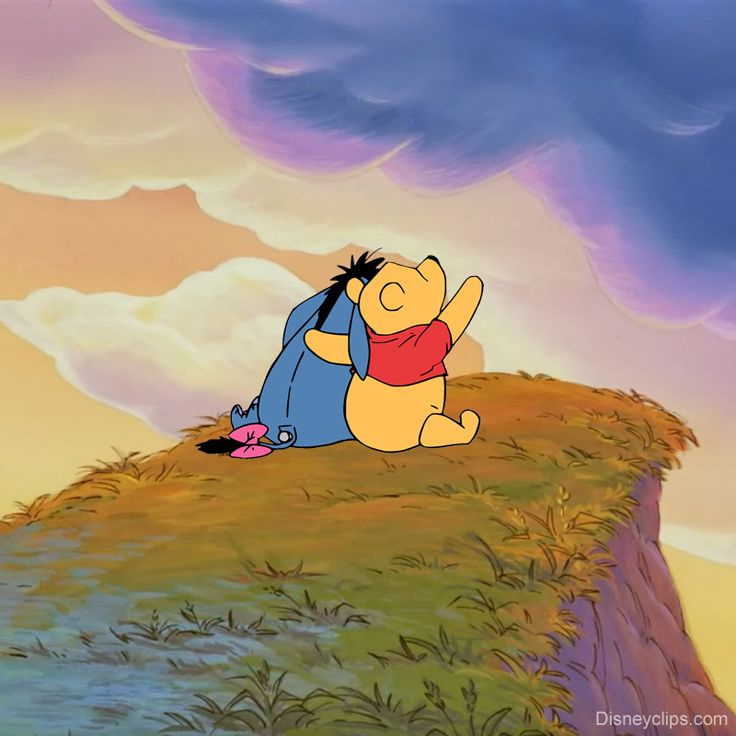 winnie the pooh sitting on top of a hill with his arms around her body