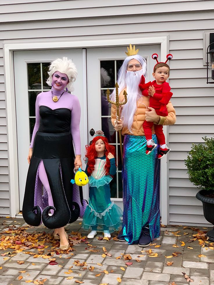 three people dressed up as the little mermaids and king nala are standing in front of a house