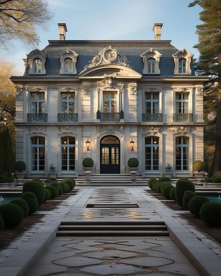 a large white building with many windows and steps leading up to the front door area