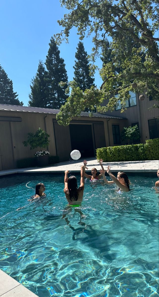 several people are playing frisbee in the pool