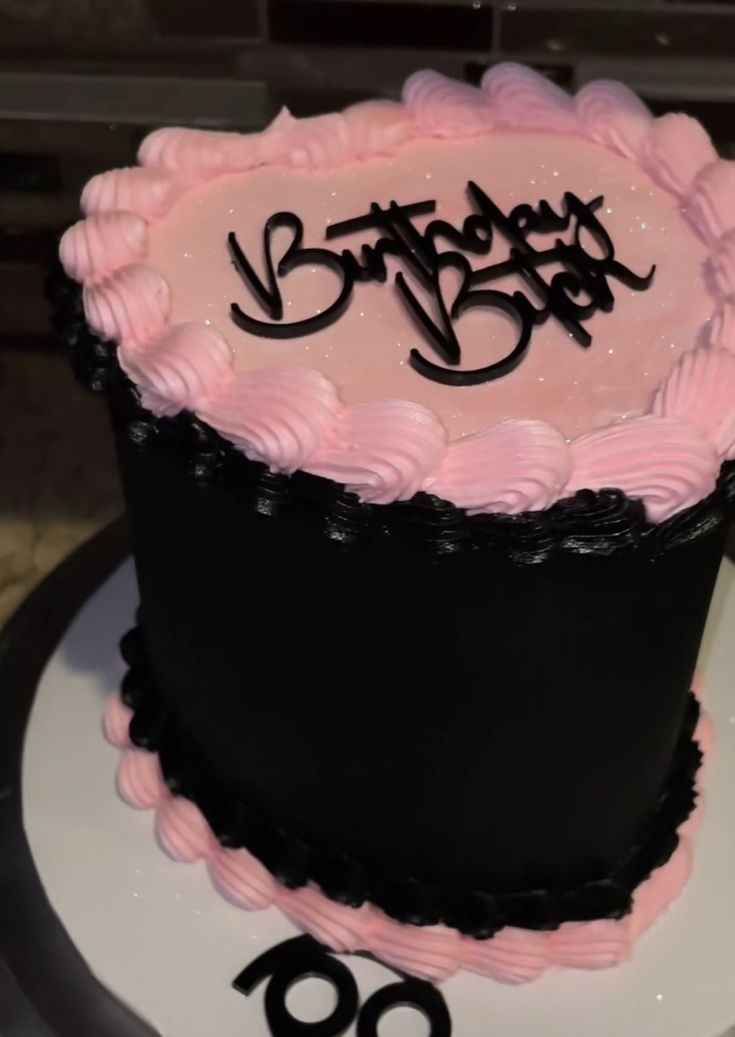 a pink and black birthday cake with the number 80 on it